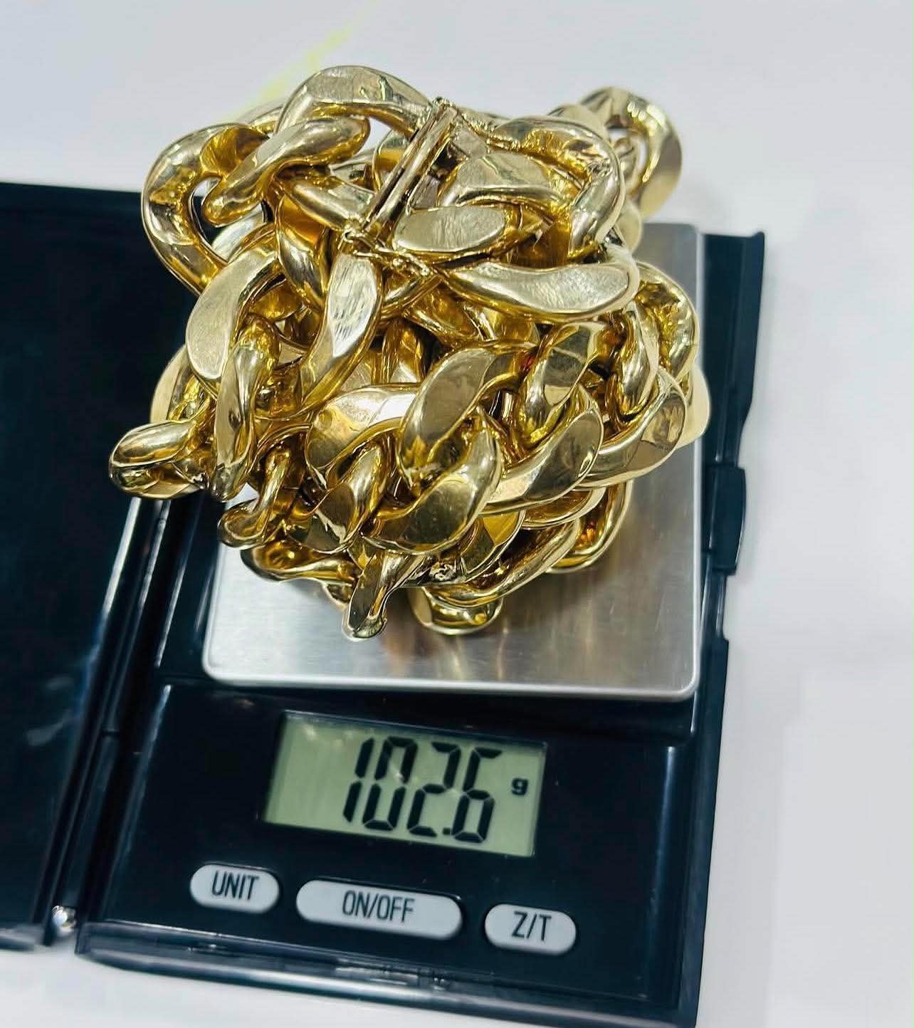 A heavy gold chain weighed on a precision scale