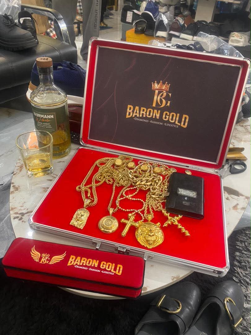 A Baron Gold case filled with gold chains and pendants